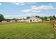 Well-maintained backyard featuring a large grassy area and wooden fence, ideal for outdoor activities and privacy at 908 Dairy Meadow Ct, Monroe, NC 28110