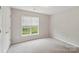Bedroom featuring neutral walls, plush carpeting, closet with double doors, and a window at 908 Dairy Meadow Ct, Monroe, NC 28110