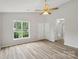 Bright, spacious bedroom featuring hardwood flooring and a large window with backyard views at 908 Dairy Meadow Ct, Monroe, NC 28110