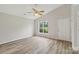 Bright bedroom with light grey walls, ceiling fan, and hardwood floors at 908 Dairy Meadow Ct, Monroe, NC 28110