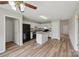 Bright kitchen boasts an island, granite countertops, white cabinetry, and black appliances at 908 Dairy Meadow Ct, Monroe, NC 28110