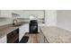 Close up on modern kitchen features granite counters and black appliances at 908 Dairy Meadow Ct, Monroe, NC 28110