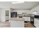 Spacious kitchen with island and white cabinetry, complemented by black appliances at 908 Dairy Meadow Ct, Monroe, NC 28110