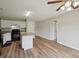 Bright kitchen boasts an island with granite countertops and natural-tone flooring at 908 Dairy Meadow Ct, Monroe, NC 28110