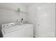 Laundry room featuring a washer and dryer, door, and a storage shelf at 908 Dairy Meadow Ct, Monroe, NC 28110