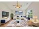 Bright staged living room with large window, ceiling fan, and comfortable seating arrangement at 908 Dairy Meadow Ct, Monroe, NC 28110