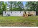 Exterior home view highlighting the rear wooden deck and large, open backyard at 925 Crestland Dr, Clover, SC 29710