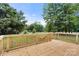 A newly constructed wooden deck features backyard views of mature shade trees at 925 Crestland Dr, Clover, SC 29710