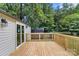 Expansive wooden deck perfect for entertaining with railing and view of the wooded backyard at 925 Crestland Dr, Clover, SC 29710