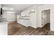 Open concept kitchen with white cabinets, granite countertops, and wood-look flooring at 925 Crestland Dr, Clover, SC 29710