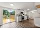 Well-lit kitchen with access to a deck, featuring modern appliances and white cabinetry at 925 Crestland Dr, Clover, SC 29710