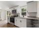 Modern kitchen showcasing white cabinets, granite countertops, and stainless steel appliances at 925 Crestland Dr, Clover, SC 29710