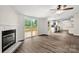 Bright living room with a fireplace, sliding glass doors to the deck, and open kitchen access at 925 Crestland Dr, Clover, SC 29710
