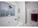 Bright bathroom features a soaking tub under a window and a glass-enclosed shower at 9359 Hillston Ridge Rd, Huntersville, NC 28078
