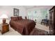 Bedroom features a large bed with decorative cushions and a side table with nightstand at 9359 Hillston Ridge Rd, Huntersville, NC 28078