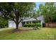 Beautiful front yard with mature tree and manicured shrubs enhance curb appeal at 9359 Hillston Ridge Rd, Huntersville, NC 28078