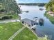 Aerial view of the property, highlighting the waterside structure, boat dock, and lush landscaping at 108 Balmoral Dr, Mooresville, NC 28117