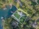 Aerial view showcasing the property's expansive grounds, waterfront access, and mature trees at 108 Balmoral Dr, Mooresville, NC 28117