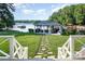 Expansive backyard with a well-maintained lawn, leading to a charming gazebo by the lake at 108 Balmoral Dr, Mooresville, NC 28117