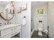 Elegant bathroom featuring marble vanity, stylish fixtures, and a black-and-white tiled shower with glass door at 108 Balmoral Dr, Mooresville, NC 28117