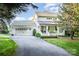 Charming home featuring a covered front porch, well-maintained landscaping, and an attached garage at 108 Balmoral Dr, Mooresville, NC 28117
