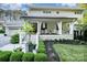Inviting front porch with classic columns, stylish decor, and professionally landscaped garden beds at 108 Balmoral Dr, Mooresville, NC 28117