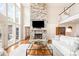 Cozy living room with a stone fireplace, floor to ceiling windows, and stylish furniture at 108 Balmoral Dr, Mooresville, NC 28117