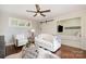 Charming living room with white sofa, striped armchairs, and a decorative cowhide rug on the dark-stained wood floor at 108 Balmoral Dr, Mooresville, NC 28117