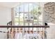 Living room featuring a wall of windows with lake views and a stone fireplace at 108 Balmoral Dr, Mooresville, NC 28117
