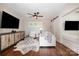 Cozy living room with hardwood floors, modern furnishings, and a barn door accent to the side bedroom at 108 Balmoral Dr, Mooresville, NC 28117