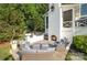 Inviting outdoor living space featuring a stone patio, fireplace, built-in grill, and comfortable seating area at 108 Balmoral Dr, Mooresville, NC 28117