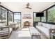 Relaxing porch with a fireplace, comfortable seating, and serene lake views at 108 Balmoral Dr, Mooresville, NC 28117