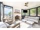Inviting porch with a brick fireplace and comfortable seating, perfect for enjoying the lake views at 108 Balmoral Dr, Mooresville, NC 28117