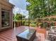 Relaxing back deck with wicker furniture and scenic backyard views, ideal for outdoor gatherings and leisure at 10924 Lederer Ave, Charlotte, NC 28277