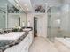 Bathroom featuring double sinks, granite counters, and a glass enclosed shower at 10924 Lederer Ave, Charlotte, NC 28277
