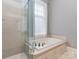 Bathroom featuring a large soaking tub and glass shower at 10924 Lederer Ave, Charlotte, NC 28277