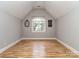 Bright bedroom with hardwood floors, a window with natural light, and neutral paint creating a calming space at 10924 Lederer Ave, Charlotte, NC 28277