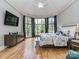 Primary bedroom with tray ceilings, ensuite bathroom and bay window at 10924 Lederer Ave, Charlotte, NC 28277