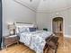Bedroom featuring a tray ceiling, hardwood floors, and an ensuite bathroom at 10924 Lederer Ave, Charlotte, NC 28277
