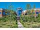 Beautiful view of the building exterior with many trees planted throughout the landscaped green space at 10924 Lederer Ave, Charlotte, NC 28277