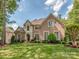 Beautiful brick home with a well-manicured lawn and lush landscaping at 10924 Lederer Ave, Charlotte, NC 28277