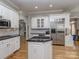 Modern kitchen features stainless steel appliances, island, granite countertops, and wood floors at 10924 Lederer Ave, Charlotte, NC 28277