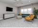 Living room boasting a plush green sofa and a large flat screen tv at 10924 Lederer Ave, Charlotte, NC 28277