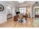 Bright home office with a wooden desk, hardwood floors, and ample natural light at 10924 Lederer Ave, Charlotte, NC 28277