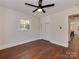 Bedroom with hardwood floors, ceiling fan, built-in storage, and a view to the outdoor scenery at 1147 Norland Rd, Charlotte, NC 28205