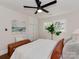 Bright bedroom features wood floors, white walls, ceiling fan, and natural light from windows at 1147 Norland Rd, Charlotte, NC 28205