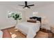 Cozy bedroom with a ceiling fan, hardwood floors, and bright natural light from two windows at 1147 Norland Rd, Charlotte, NC 28205