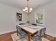 Cozy dining room with a chandelier, artwork, and a window overlooking the yard at 1147 Norland Rd, Charlotte, NC 28205