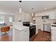 Modern kitchen with white cabinets, stainless steel appliances, and an open layout to the living space at 1147 Norland Rd, Charlotte, NC 28205