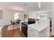 Open kitchen with stainless steel appliances, white countertops, and a seamless flow to the dining area at 1147 Norland Rd, Charlotte, NC 28205